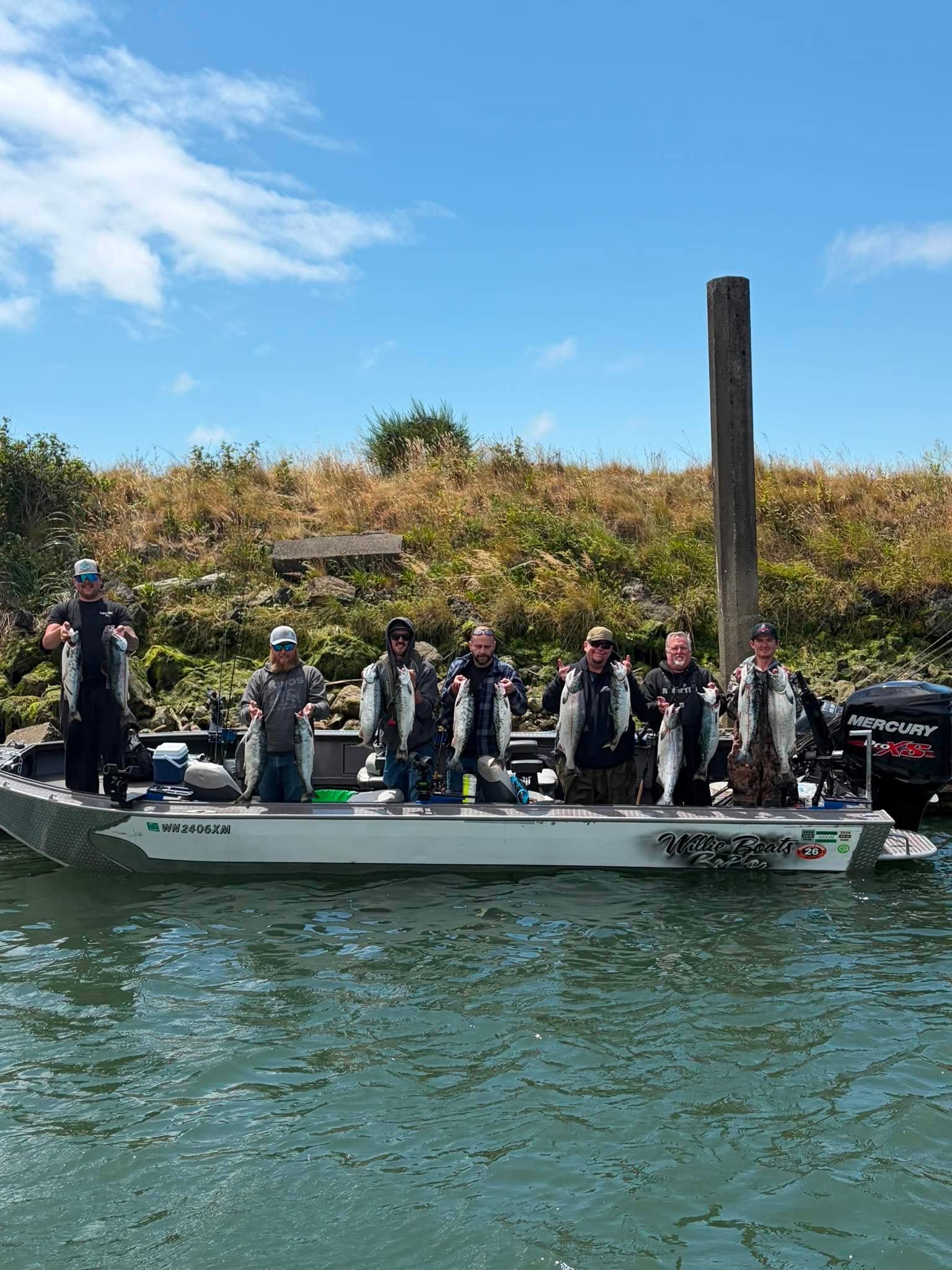 Fin Addict group displaying a successful salmon catch from the boat